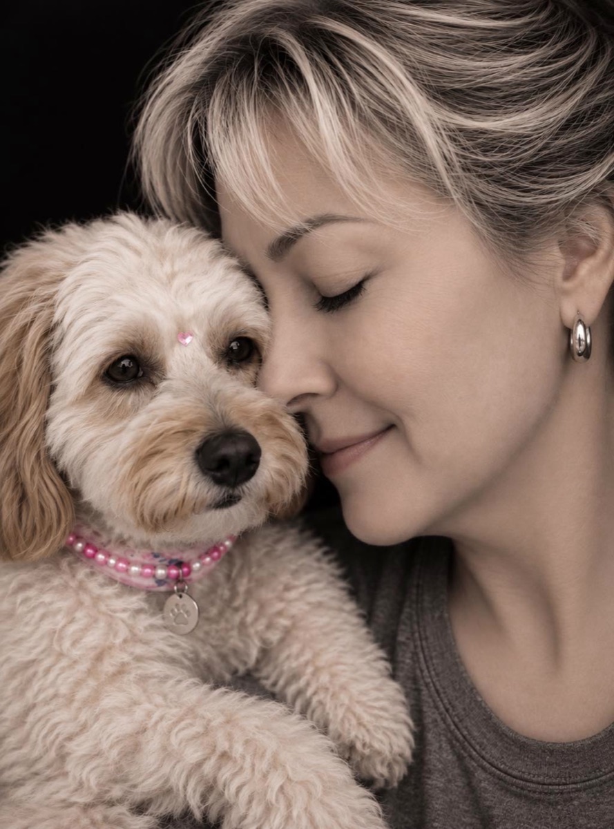 Sharie cheek to cheek with Millie Mae, her mini Goldendoodle